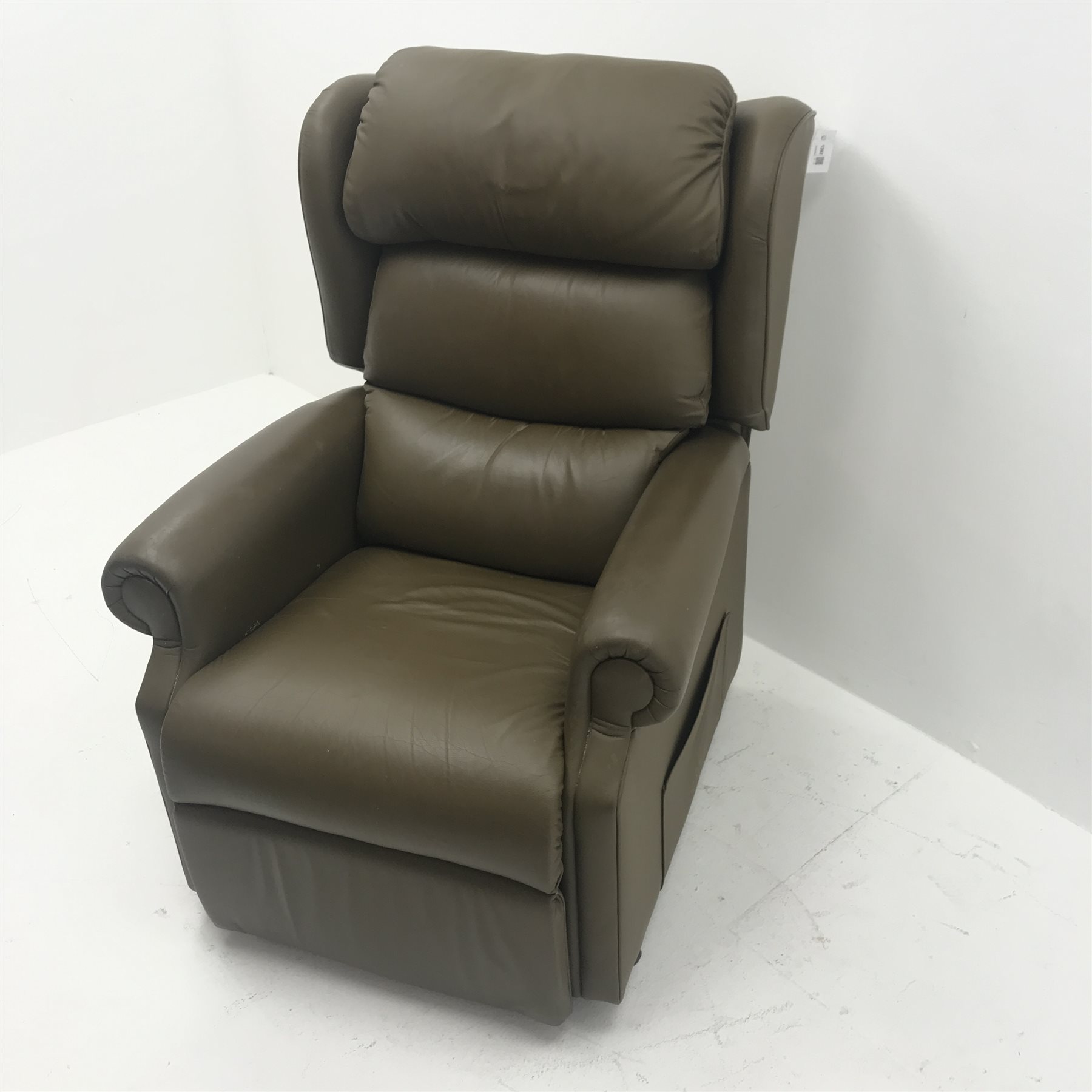 Electric reclining armchair upholstered in a green leather, W84cm The