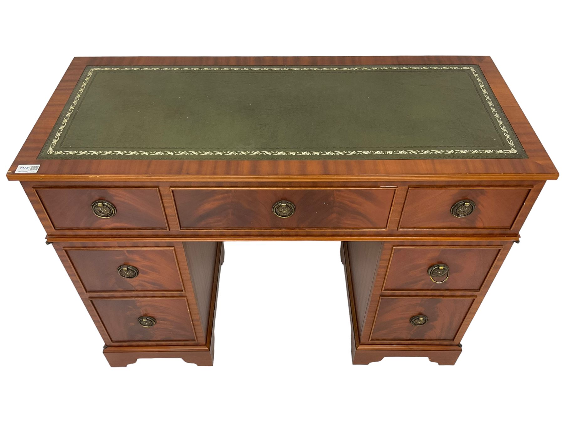 Music system in the form of a Georgian design twin pedestal desk, the reed moulded rectangular top hinges to reveal Garrard turntable with Dynatron Amplifier, fitted with speakers enclosed by two doors disguised as drawers, on bracket feet