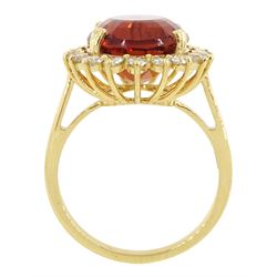 18ct gold citrine and diamond cluster ring, single oval cut citrine of approx 7.35 carat, with round brilliant cut diamond surround, stamped, total diamond weight approx 0.75 carat