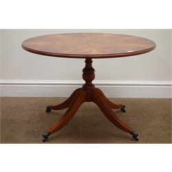  Quality yew wood circular pedestal table, cross banded and figured top on turned column, splayed supports on castors, D74cm, H50cm   
