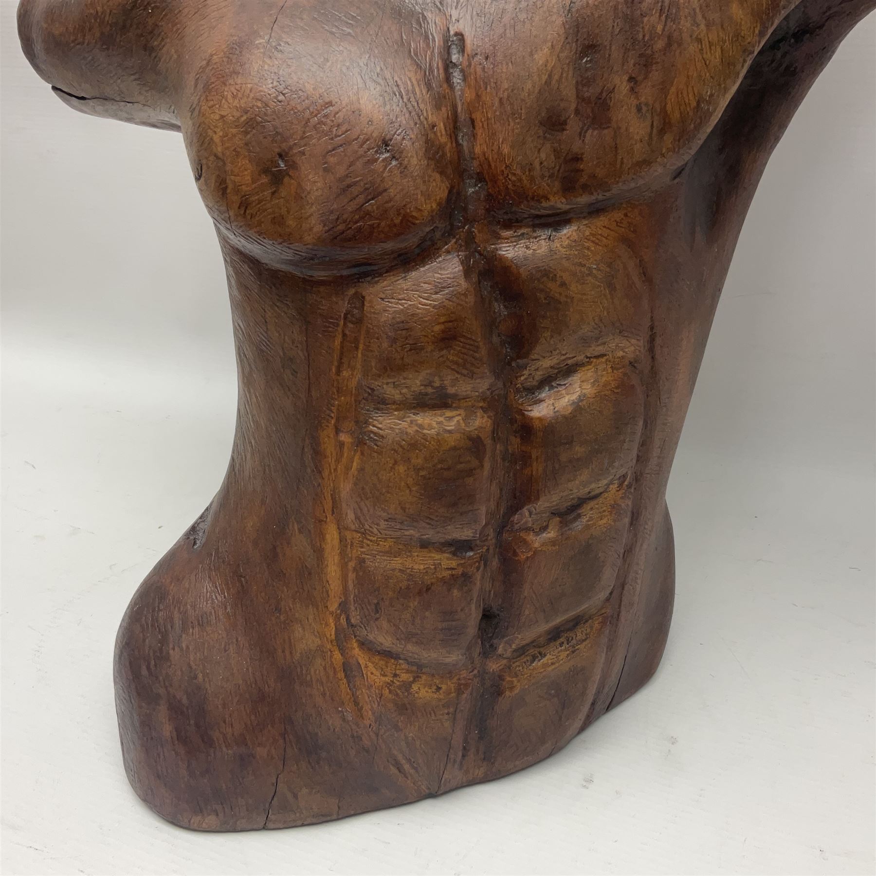 Helen Skelton (British 1933 – 2023): Large carved wooden sculpture, modelled as a male torso, H40cm. Born into an RAF family in 1933 in Kent and travelled the world extensively during her childhood. After settling in Bridlington, Helen immersed herself in painting, textiles, and wood sculpture, often inspired by nature's beauty. Her talent was showcased in a one-woman show at Sewerby Hall and recognised with the sculpture prize at Ferens Art Gallery in 2000. Sadly, Helen’s daughter passed away from cancer in 2005. This loss inspired Helen to donate her sculptures to Marie Curie upon her passing in 2023.