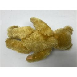 Steiff teddy bear with golden plush body, revolving head, applied eyes, vertically stitched nose and mouth and jointed limbs; button to left ear H26cm; and two other Steiff teddy bears, each with open mouth and button with tag to left ear (3)
