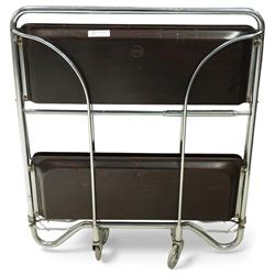 Bremshey Gerlinol - folding trolley, with arched tubular chrome supports and twin dark stained trays, raised on castors, designed to fold compactly when not in use