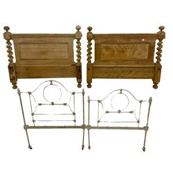 Two stripped walnut barley twist headboards, and a pair of wrought metal single bed ends