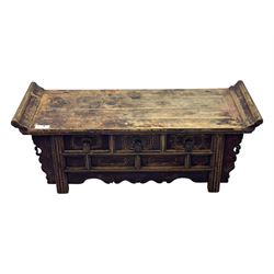 Mid-19th century elm low altar table, rectangular top with scrolled ends, fitted with three small drawers, pierced and scroll carved brackets, on square moulded supports 