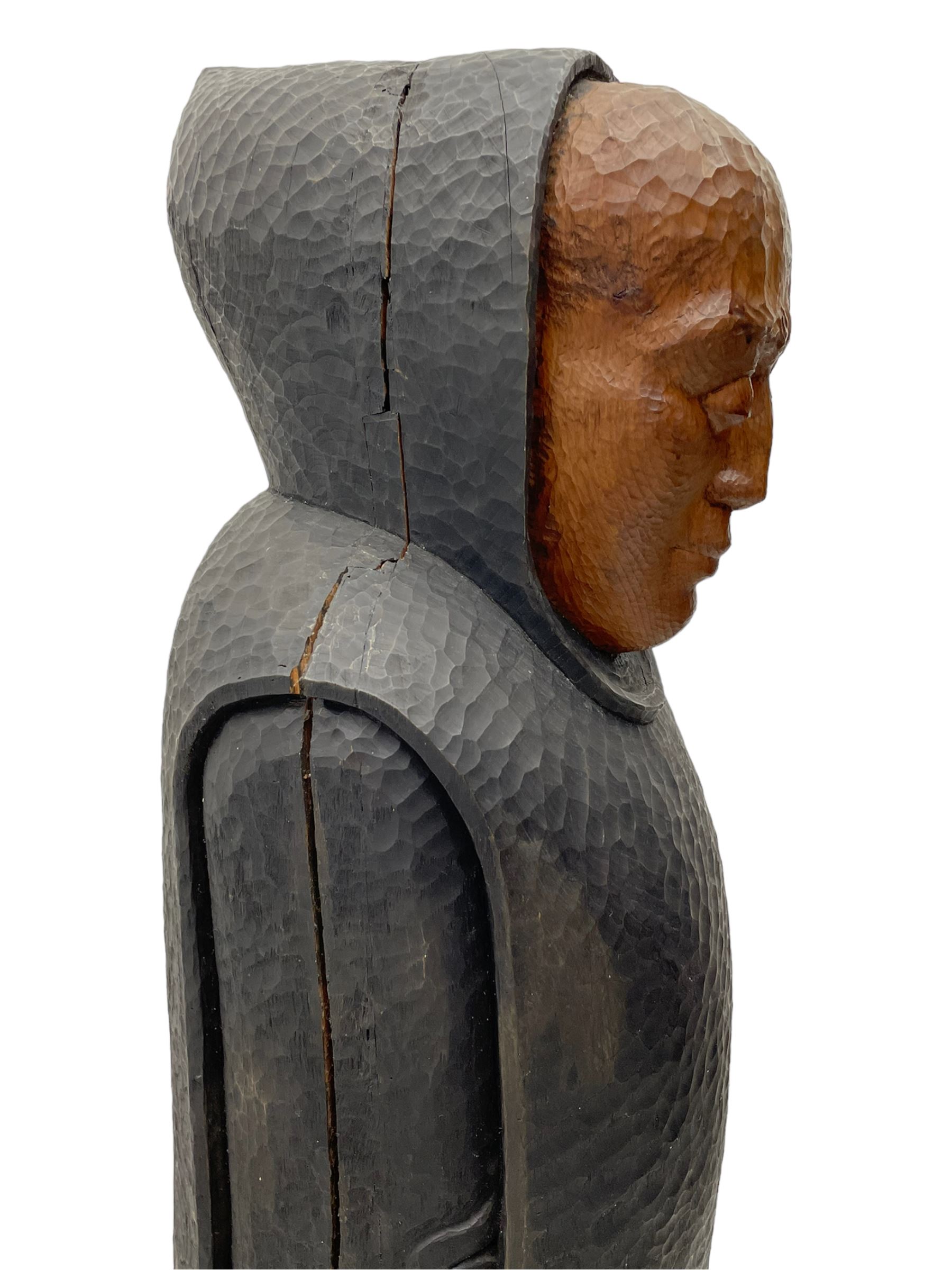 John Bunting FRBS, FRCA (1927-2002): Carved sculpture of a standing Monk in ebonised robes