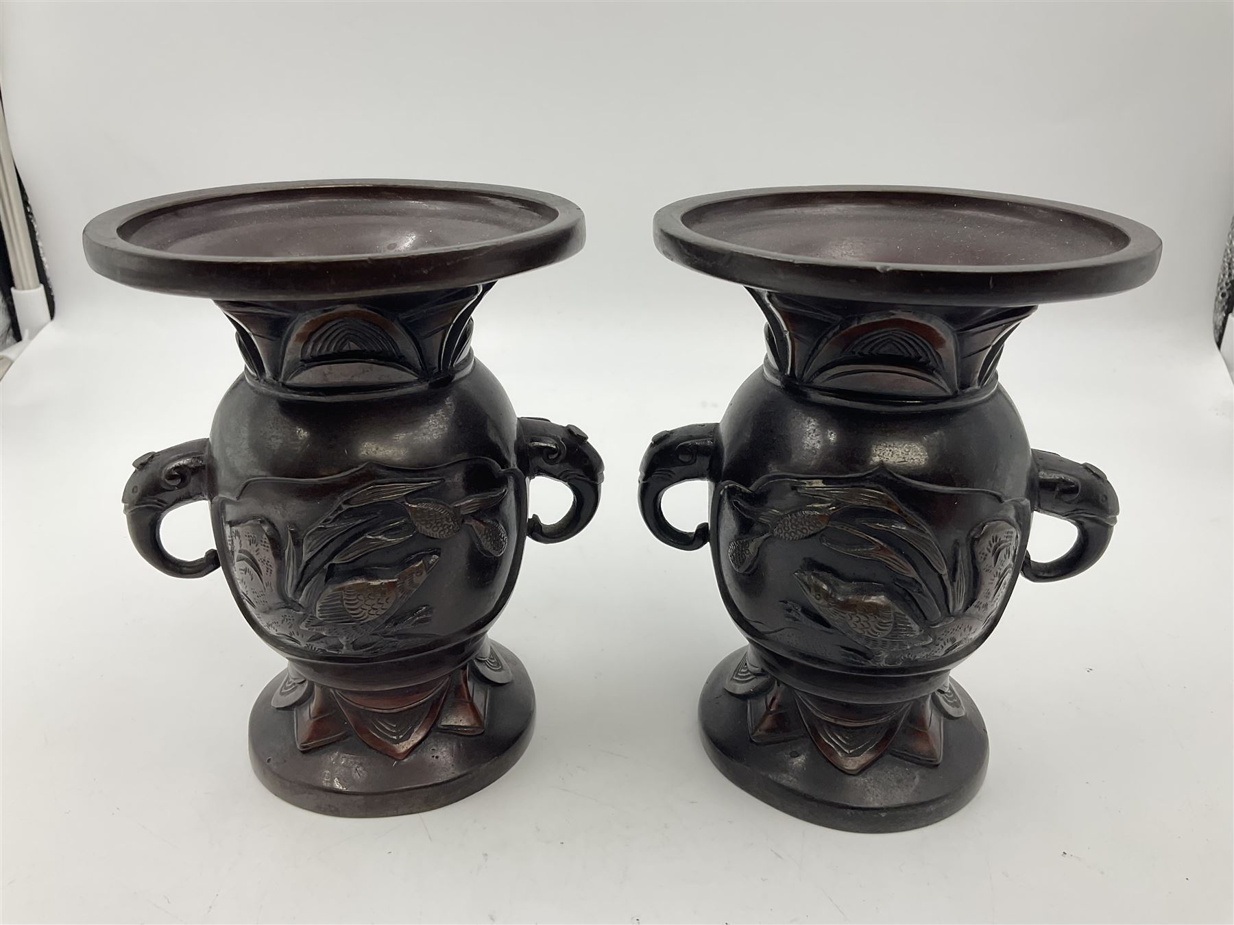 Chinese bronze vase, of baluster form with elongated neck, decorated in relief with birds amongst prunus blossom, together with a smaller pair of twin handled bronzed vases, decorated with peacocks and a blue Peking glass dish, with white metal mounted decorated with dragons, bronze vase H23.3cm