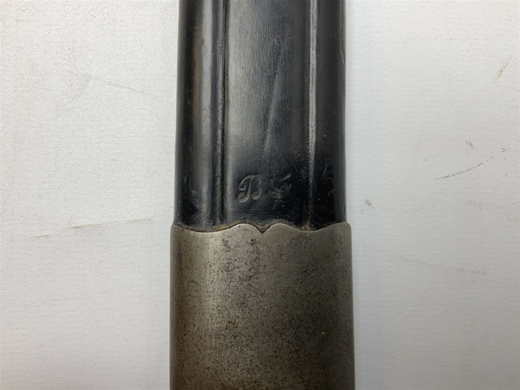 Turkish Model 1874 sword bayonet with 57.5cm curving steel fullered blade and chequered black grip, in steel mounted leather scabbard L75.5cm overall