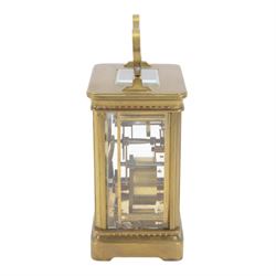 French-Edwardian 8-day timepiece carriage clock with a cylinder platform escapement, anglaise style brass case with four glass panels, dial with a polished gilt mask and foliate decoration, white enamel chapter with Arabic numerals and steel spade hands, . With Key. 