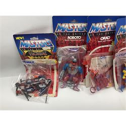 Thirty-one Masters of the Universe He-Man figures re-bagged on original backing cards;  two others lacking backing cards; boxed Modulok figure; bag of weapons and accessories; Roton, two horses and two battle cats; 1986 & 1987 Annuals; Ladybird and other story books; Panini sticker album; instructions etc