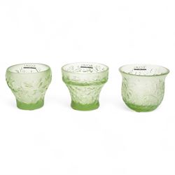 Lalique green glass tea light holder decorated with the coriandre pattern H8cm, another in the basil pattern H8cm and another with trailing leaves H8cm, all signed 'Lalique, France'