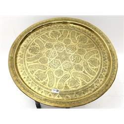  20th century Benares type table, circular brass top with engraved decoration, turned stained beech folding base, D64cm, H55cm  