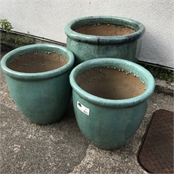 Three graduating teal glazed terracotta pots, H51cm (max)