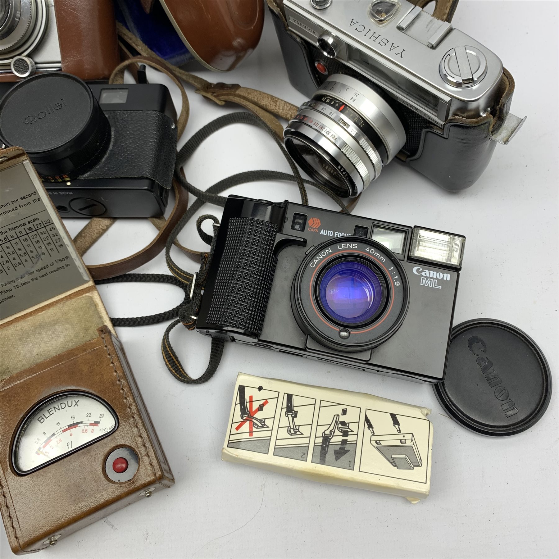 Collection of cameras to include: Polaroid 600 Land Camera SLR 680 with auto focus/auto strobe, Rollei XF 35, Canon ML AF35, Fuji TW-300, Balda Baldina Compur-Rapid, YASHICA LYNX-5000, Canon Canonet QL19, flash bar and two light meters in one box