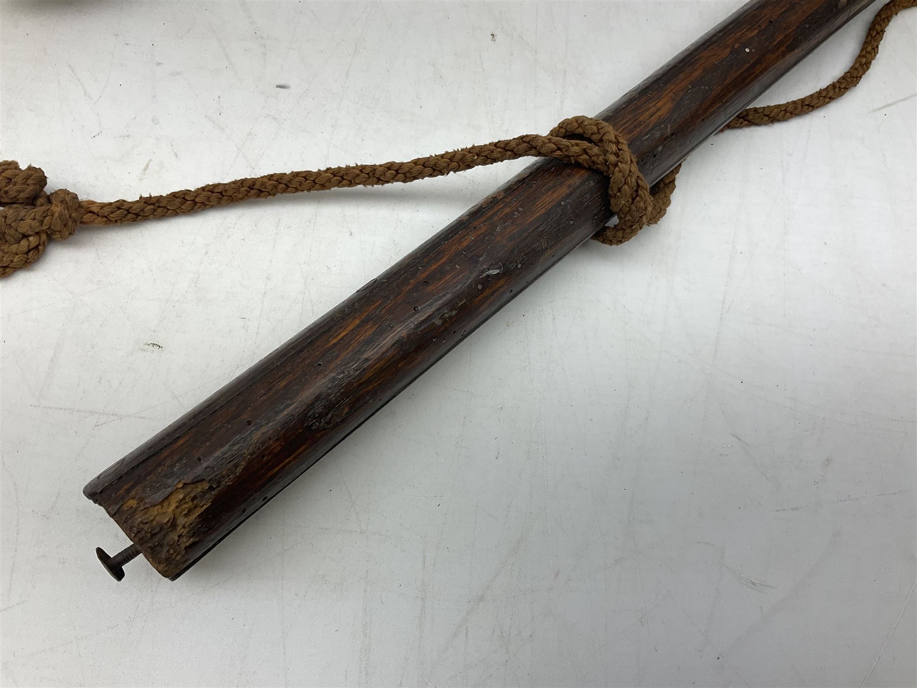 Tribal Art - an African axe, possibly Yoruba, the bone shaft carved as two cord bound stylised figures with iron fan-shaped blade, L35cm overall; and 19th century harpoon or spear head of square section with two long fixing arms on cut-down ash shaft L57cm (2)