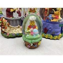 Four Disney Winnie The Pooh snow globes, comprising Pooh Graduation, Valentine, Easter Pooh and Candy Store, together with two water globes comprising Pooh Easter and Hanukah Party, all with boxes (6)