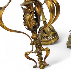 Early 20th century brass three-light chandelier, with Art Nouveau style curved and foliate ornamentation, the hanging branches formed as budding flowers with petal adornments, the bulb holders having pierced decoration to bowls, H43cm; together with two wall sconces
