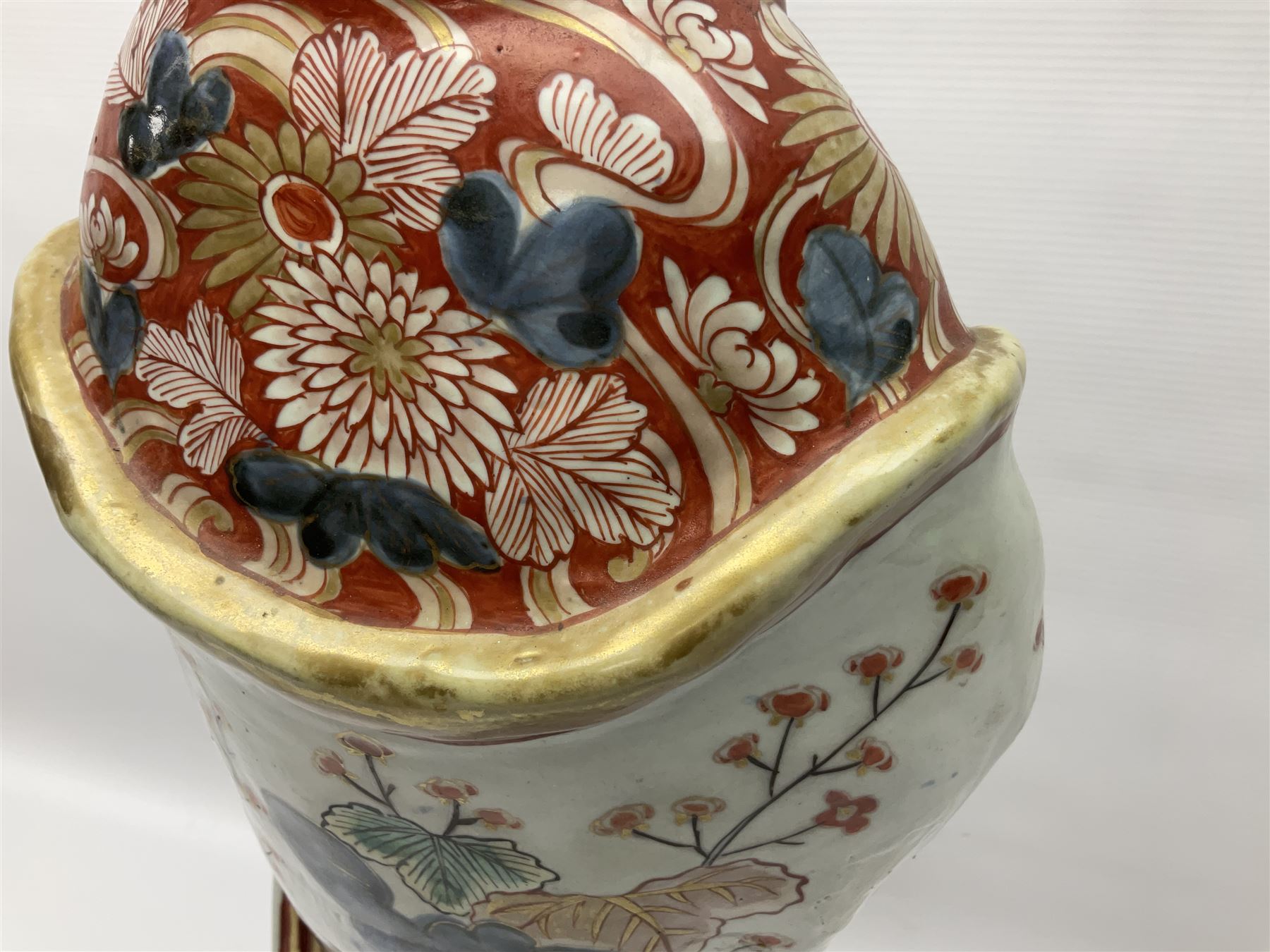 Large Japanese Imari porcelain figure, modelled as a Bijin, wearing a long kimono decorated with apple blossom and leafy branches on a white ground, with gilt detailing, possibly Edo period, H63cm