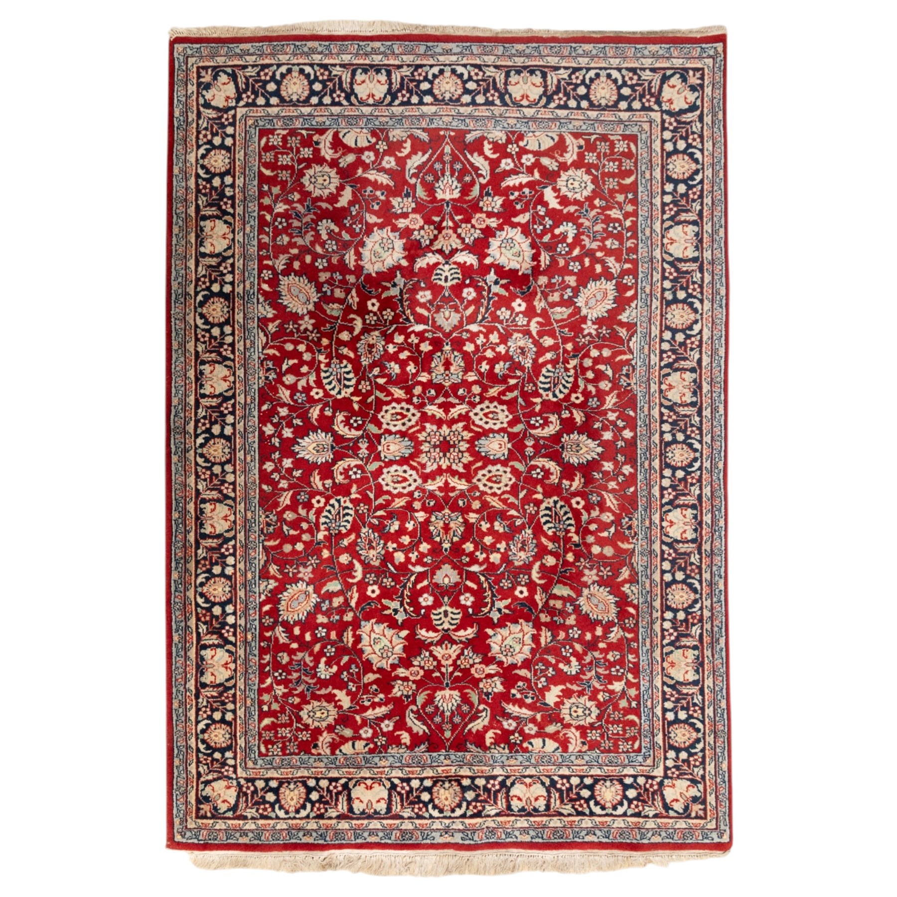 Persian crimson ground rug, interlacing floral stems linking ivory palmettes, rosettes and serrated leaves, within a navy floral border flanked by ivory patterned guards