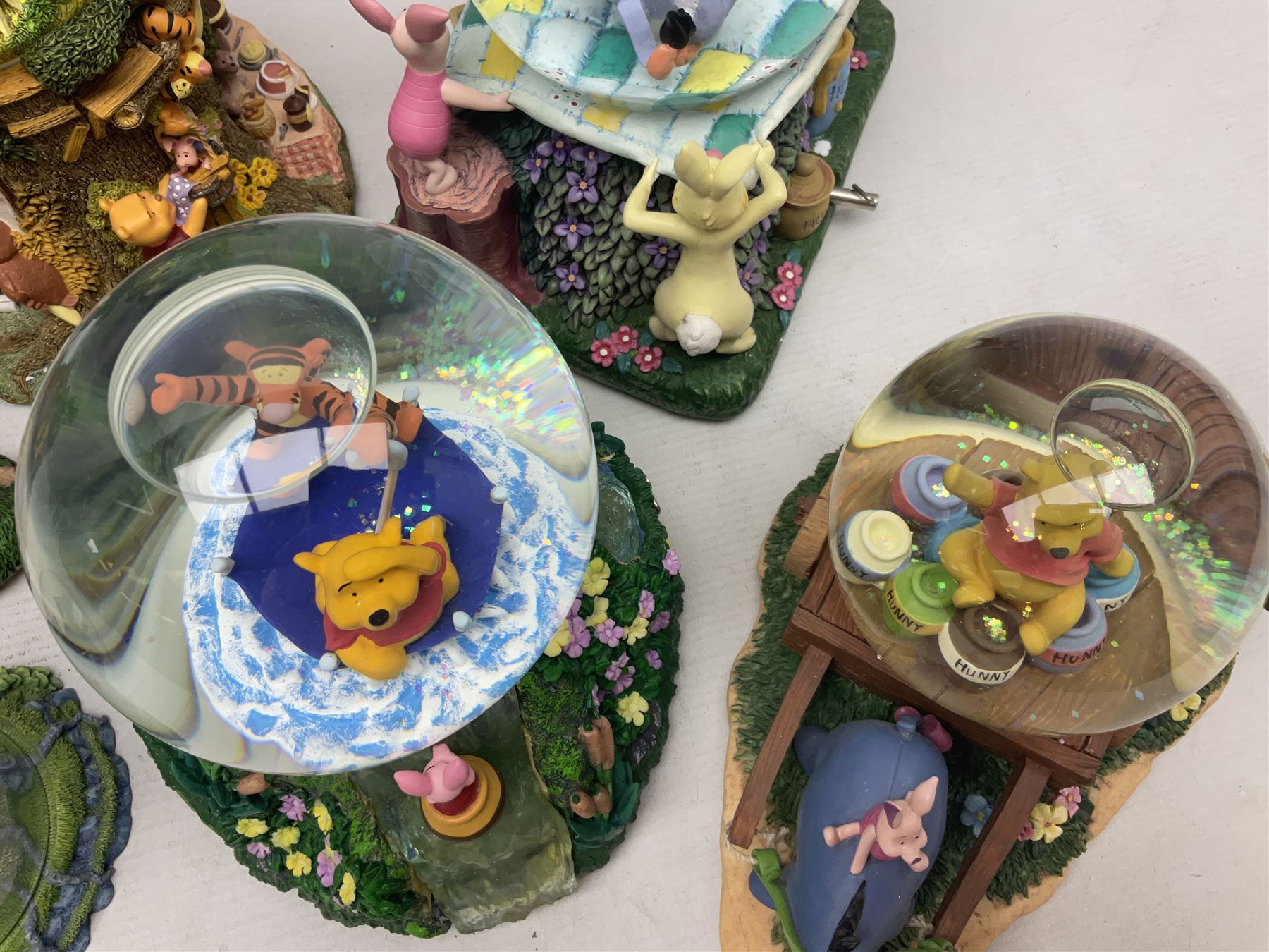Five Disney Winnie The Pooh snow globes to include The Rain Rain Rain Came Down Down Down, Eeyore Pulling Cart, Owl's House, Rumbly in My Tumbly and Stuck In Rabbit's House, together with figure group with dome, five with boxes (6)