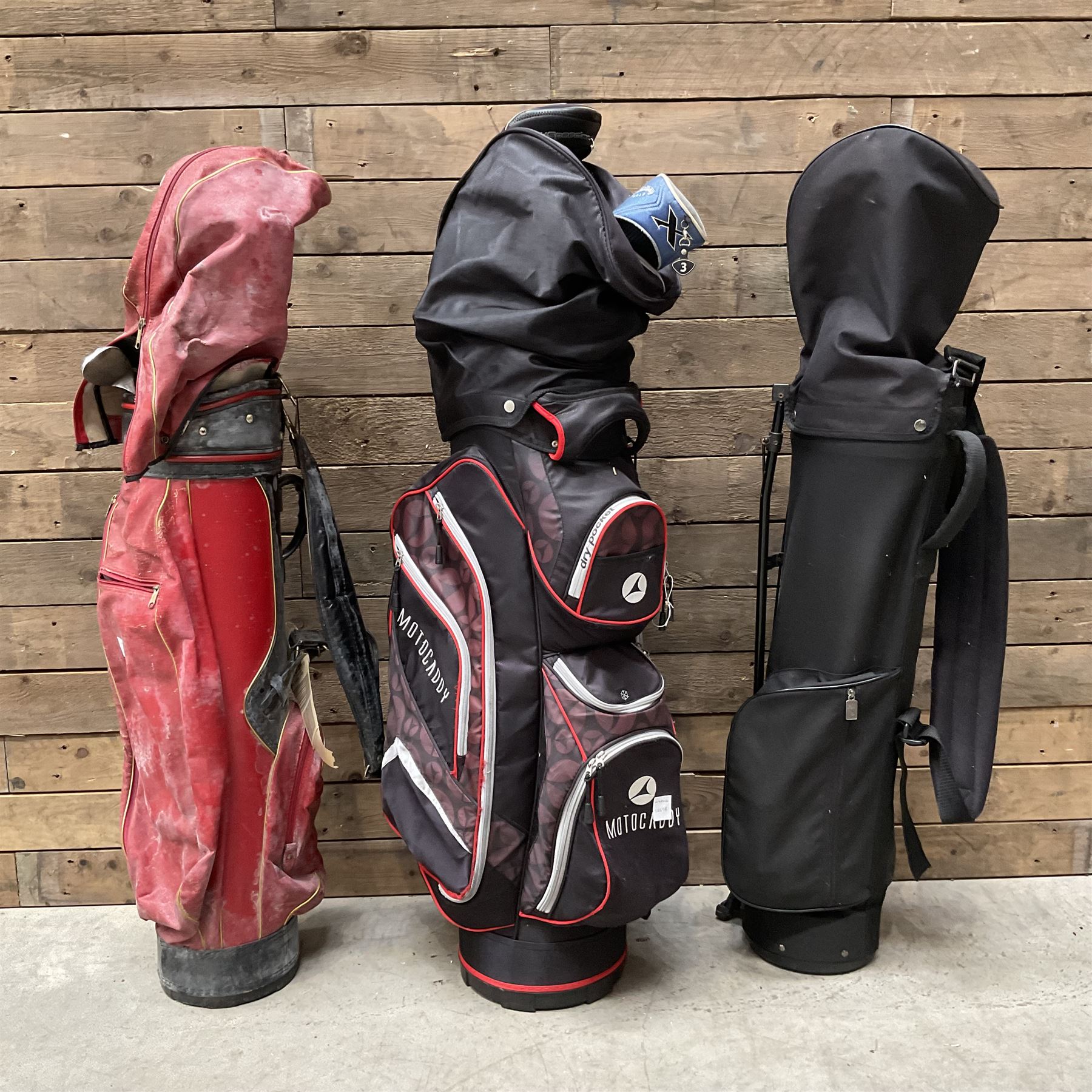 Various golf clubs in three bags