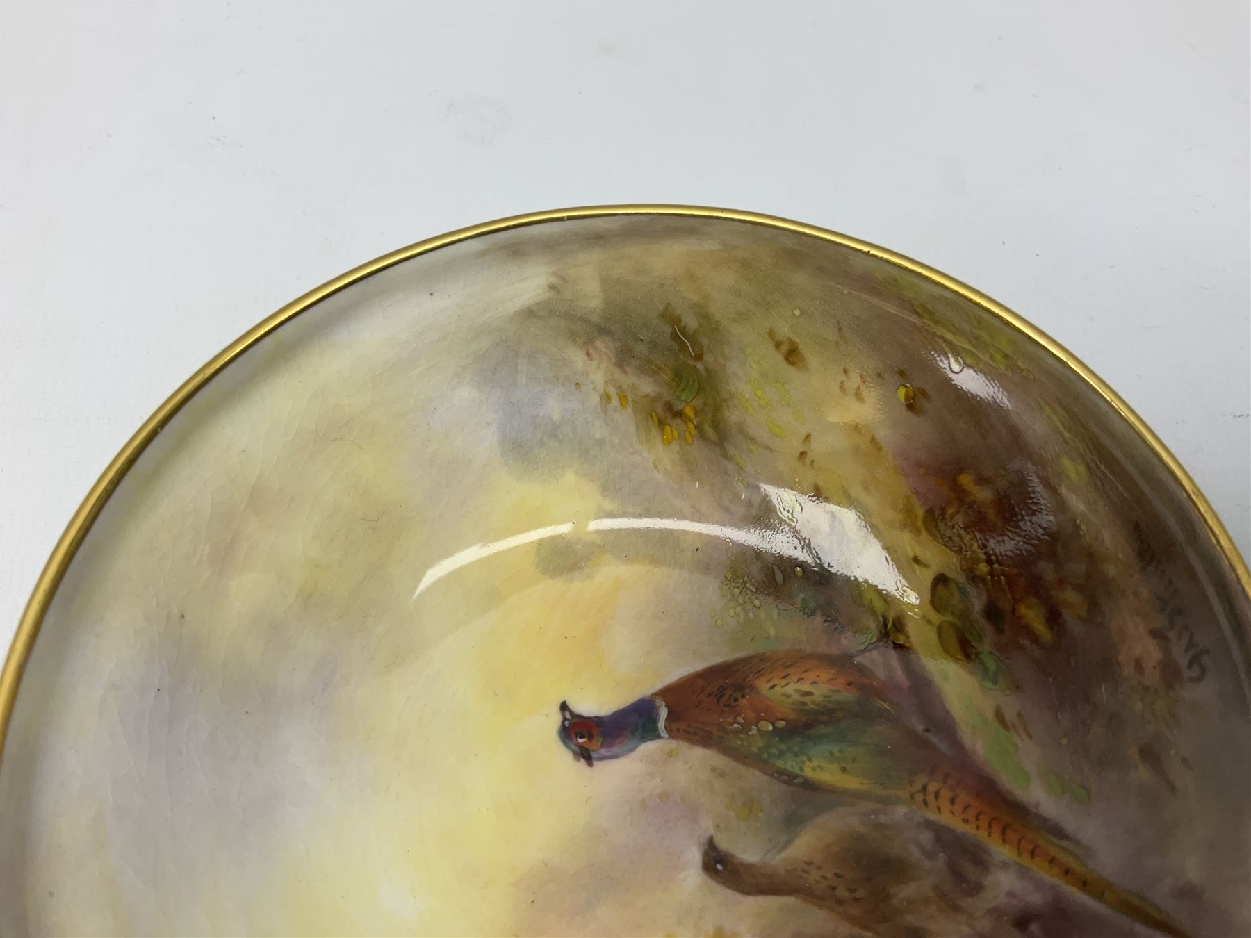 1938 Royal Worcester circular pedestal pin dish, decorated with pheasants in a landscape by James Stinton, with printed mark beneath, D10.5cm
