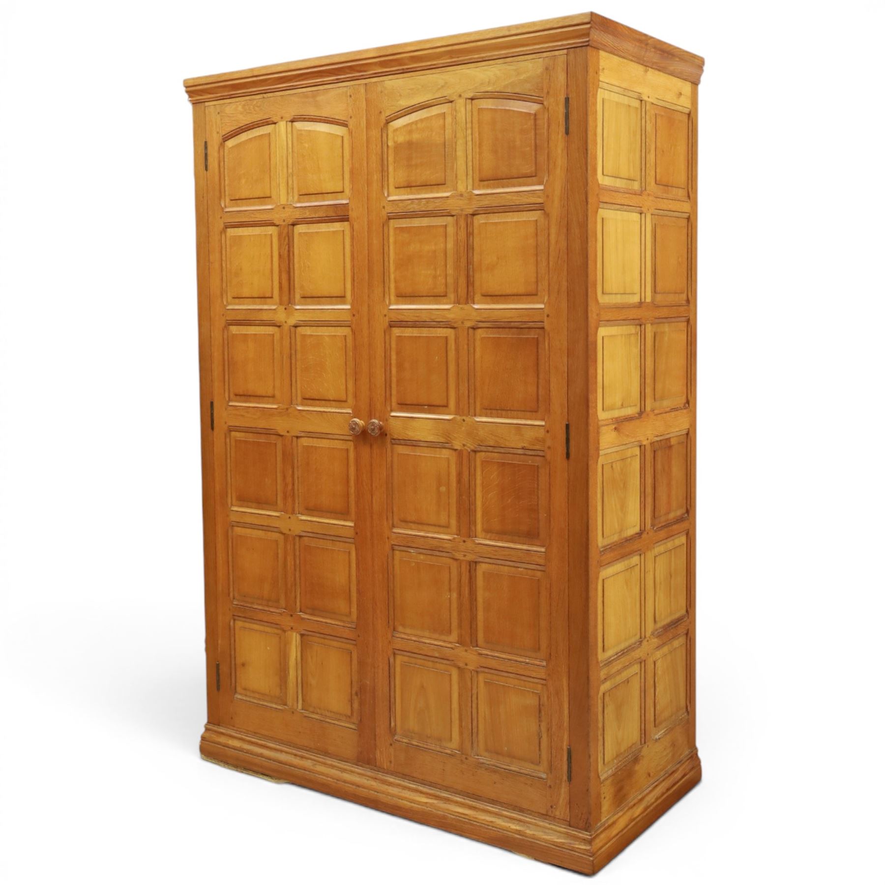 Beaverman - oak double wardrobe, enclosed by twin multi-panelled doors, Yorkshire Rose carved handles, the interior fitted with shelf and hanging rail, with signature carved beaver, by Colin Almack of Sutton, near Thirsk