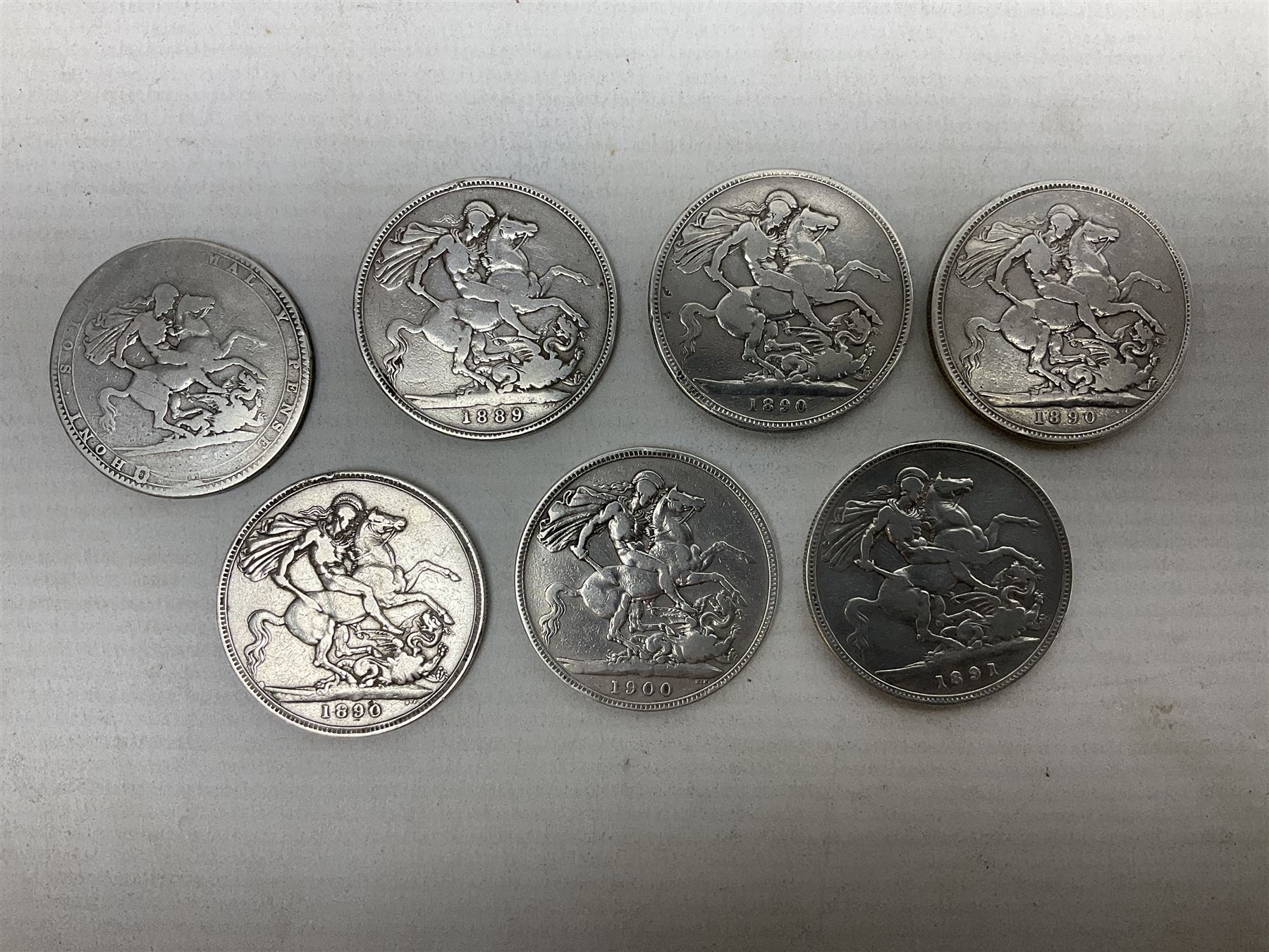 George III 1819 crown coin and six Queen Victoria crown coins dated 1889, three 1890, 1891 and 1900 (7)