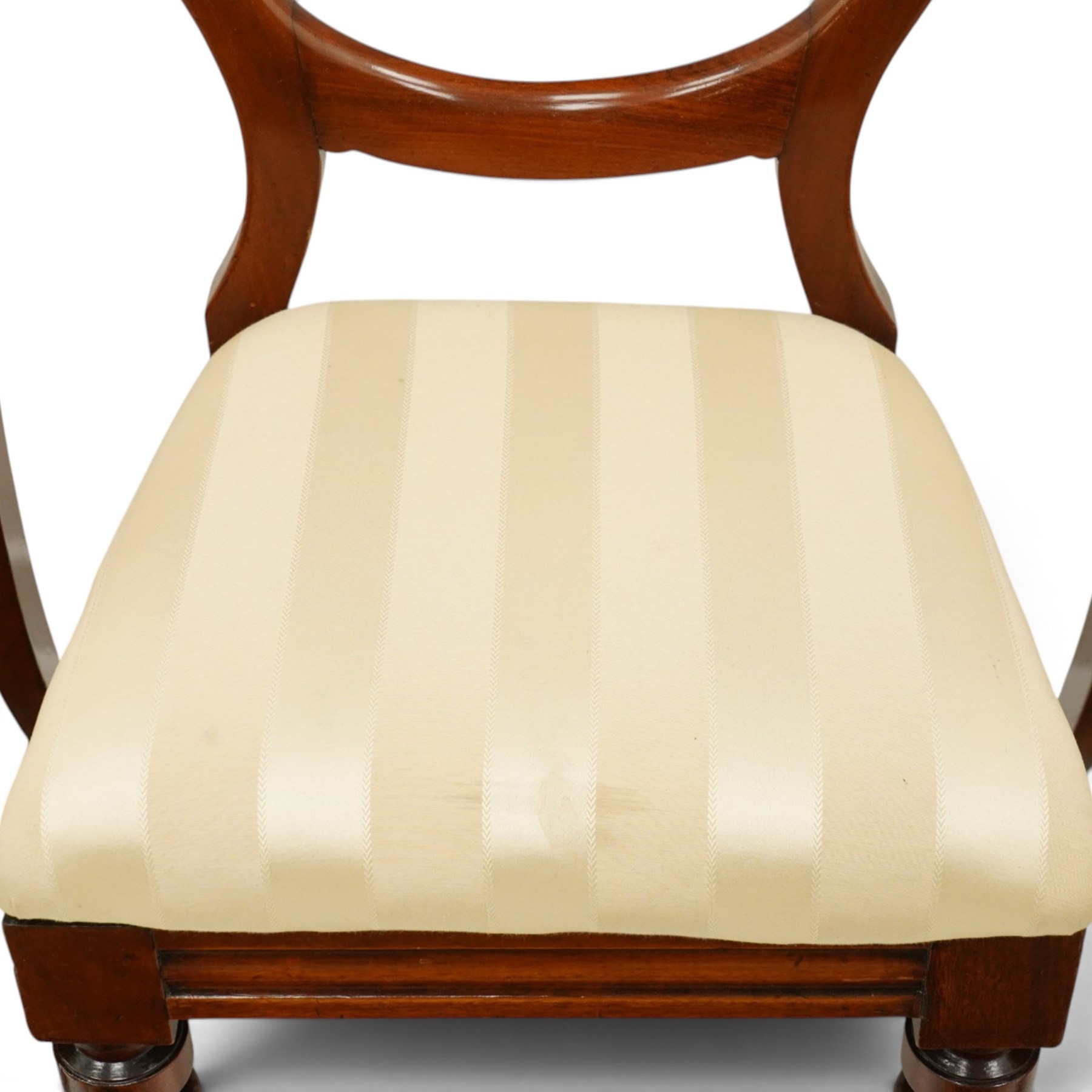 Set of twelve Victorian walnut balloon-back dining chairs, shaped open back over seats upholstered in striped ivory fabric, moulded seat rail above turned and tapering suppors