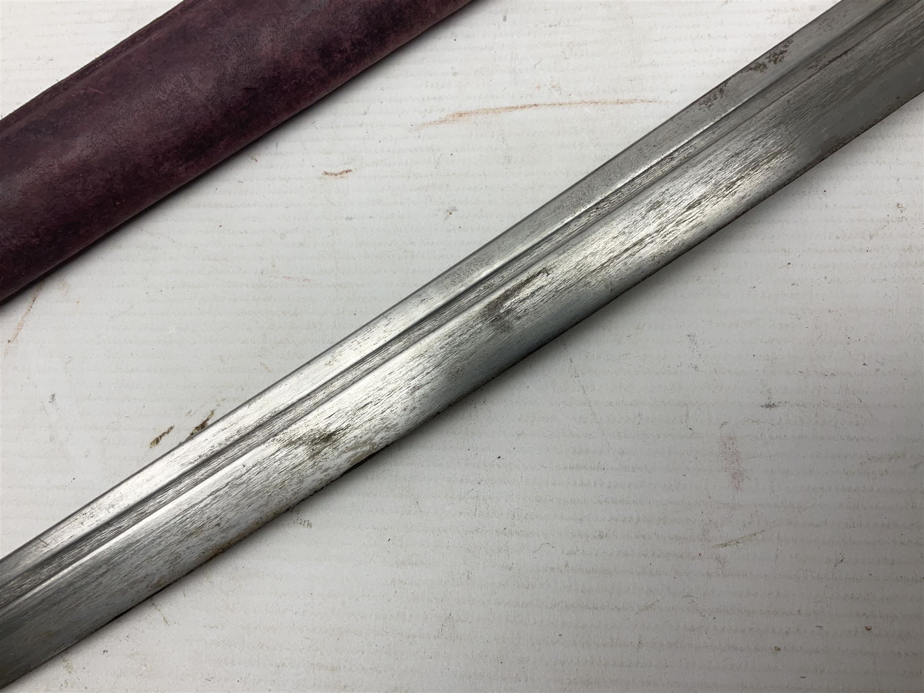 Copy of a WWII Japanese NCO sword, the 65cm slightly curving blade stamped with pseudo Japanese characters and cast brass simulated cord bound grip; in officer's leather bound field scabbard L97cm overall