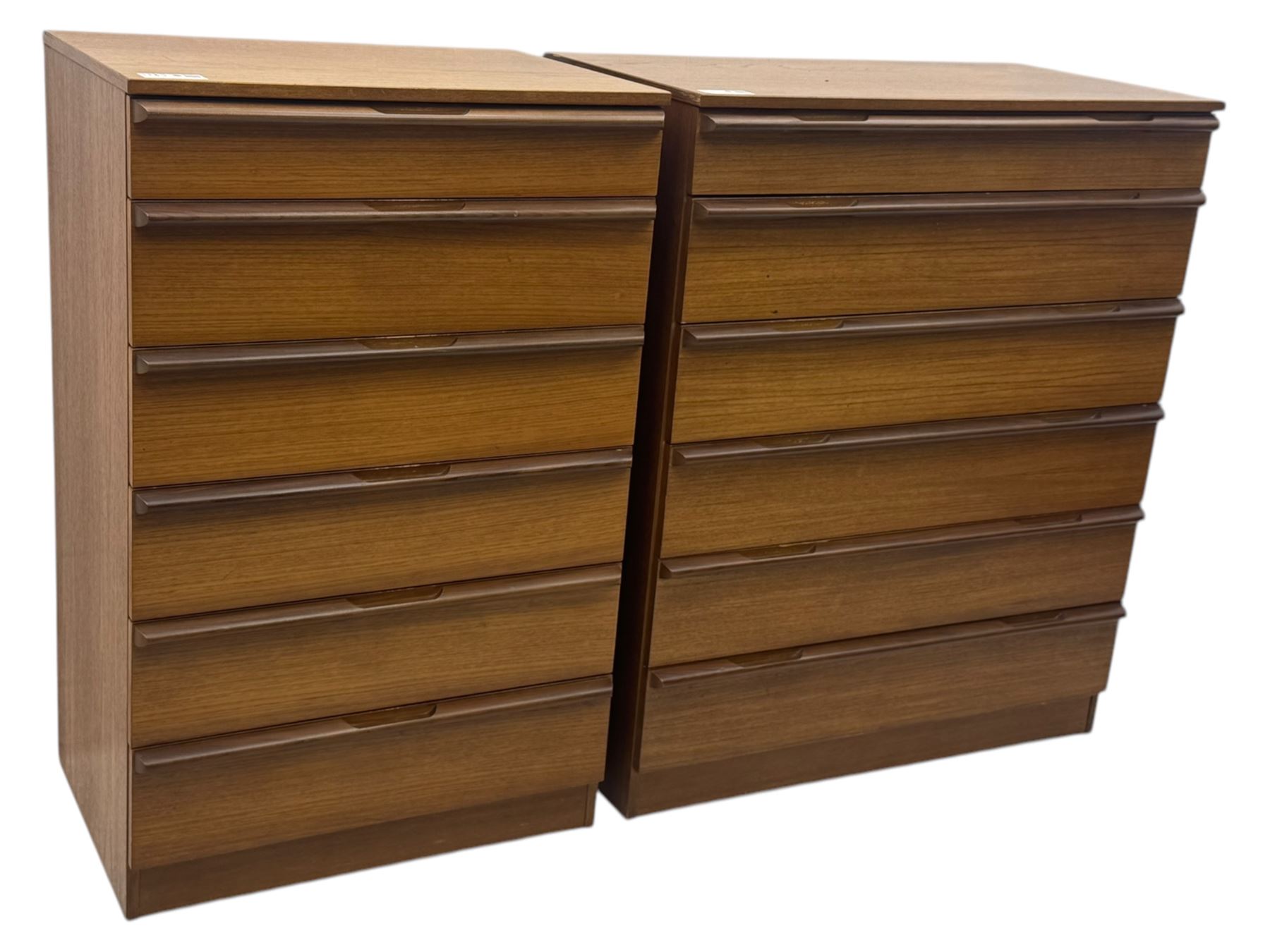 Avalon - two mid-20th century teak chests, with rectangular top above six graduated drawers, each fitted with recessed sculted pulls, raised on a flush plinth base.

(W 82cm D 55cm H 97cm)
(W 82cm D 55cm H 97cm)
