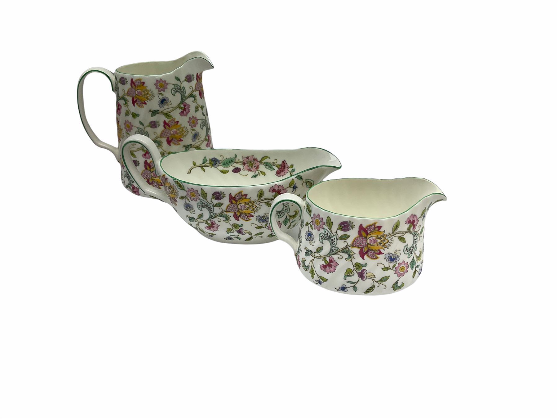 Minton Haddon Hall pattern tea and dinner wares, including basket dish, two covered tureens, six dinner plates, eight dessert plates, twelve tea plates, six soup bowls, six cereal bowls, teapot, coffee pot, milk jug, covered sucrier twelve tea cups and saucers, six mugs, footed bon bon dish, pair of candlestick holders, cake knife and slice etc (81)