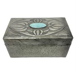 Arts & Crafts style pewter cigarette box, with planished finish to body, the hinged cover with Ruskin style oval roundel to centre, surrounded by a border of stylised flower heads, opening to reveal a compartmentalised softwood interior, H8.5cm