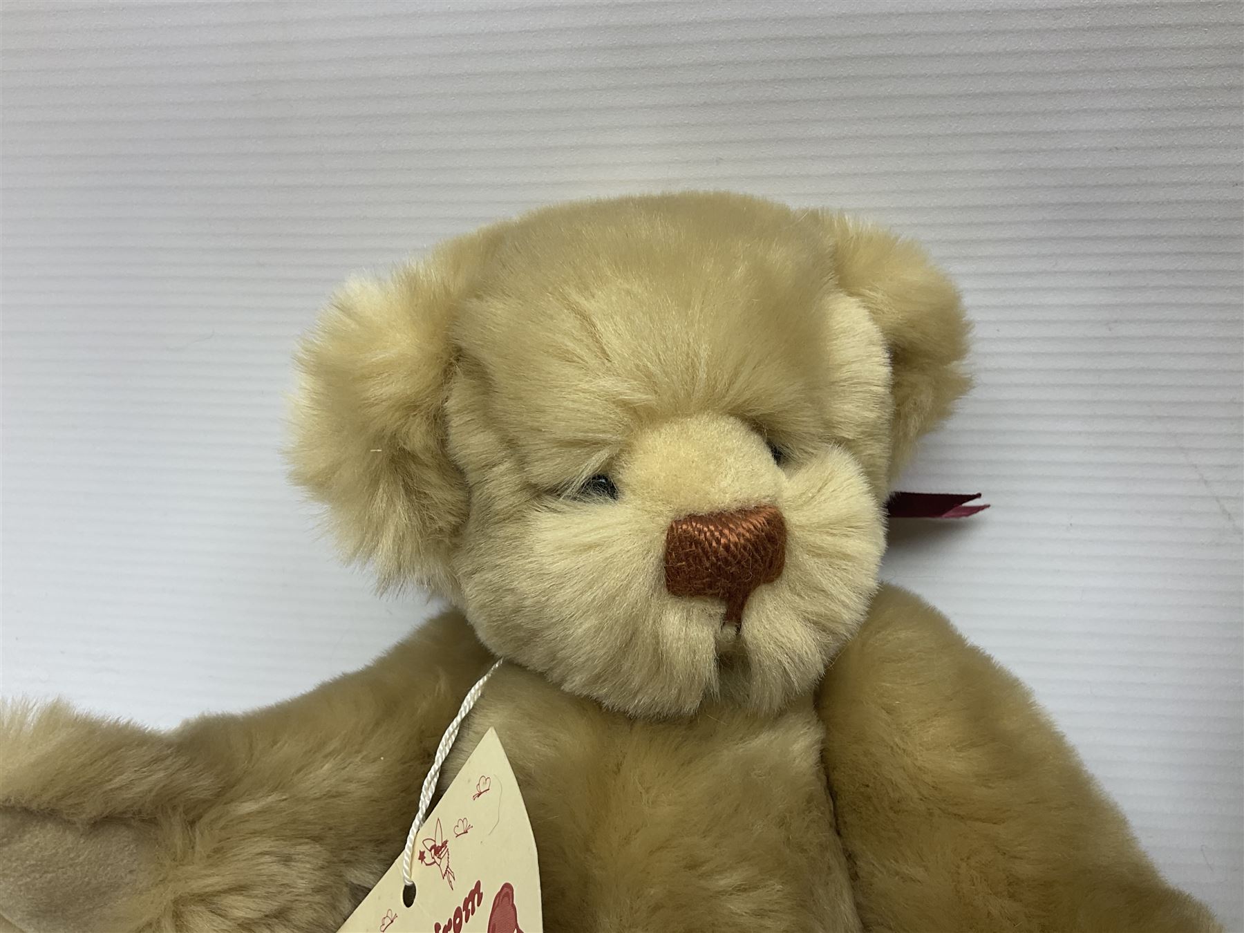 Group of five teddy bears comprising ‘George’ a unique pellet filled bear with glass eyes and velvet paws H38cm, and ‘Abbey’ a luxury German plush with wobble head and glass eyes no.5/10 H24cm, both with Teddies from Bearyland labels; along with two light blonde mohair H. M. Bears and Boyds Bears ‘T. F. Wuzzies’ no. 595140 (5)