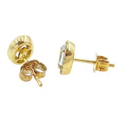 Pair of 9ct gold aquamarine and diamond earrings, each stud set with an oval cut aquamarine, with round brilliant cut diamond surround, stamped, total aquamarine weight approx 0.75 carat, total diamond weight approx 0.15 carat