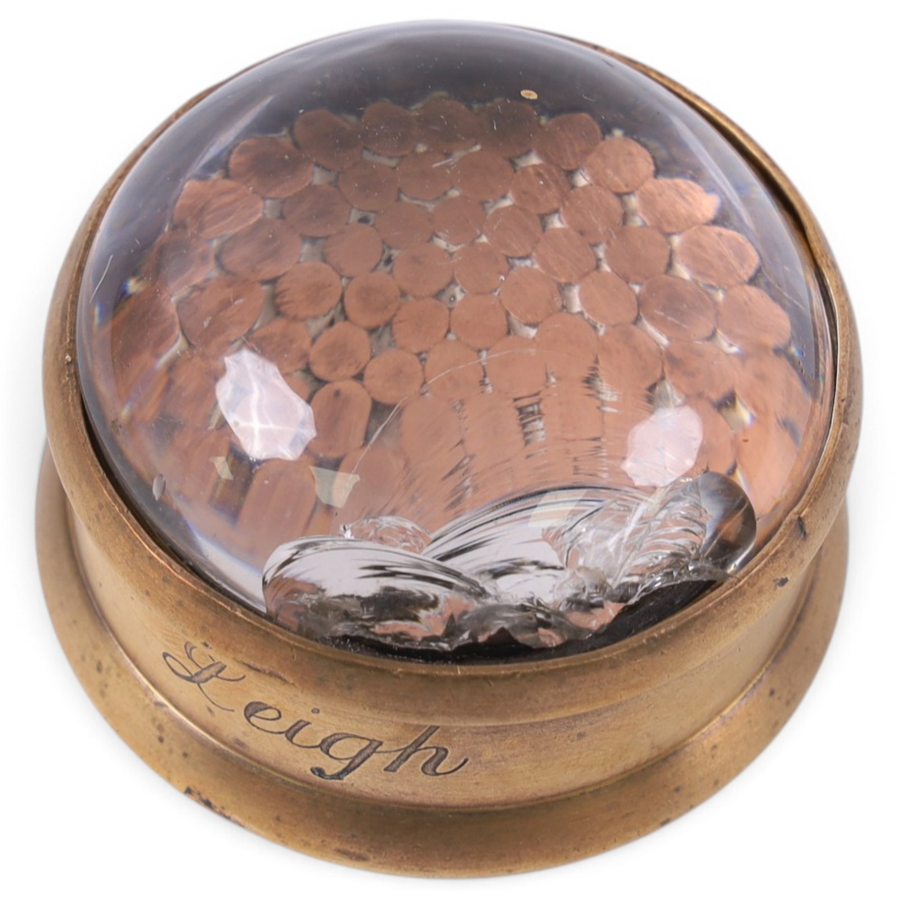 Two 1930s mining interest brass paperweights, comprising a hexagonal brass and steel example containing winding gear cables from the Wheldale Colliery and a smaller brass example with glass dome, advertising copper winding gear cables inscribed Anchor Cable Co, tallest H3cm