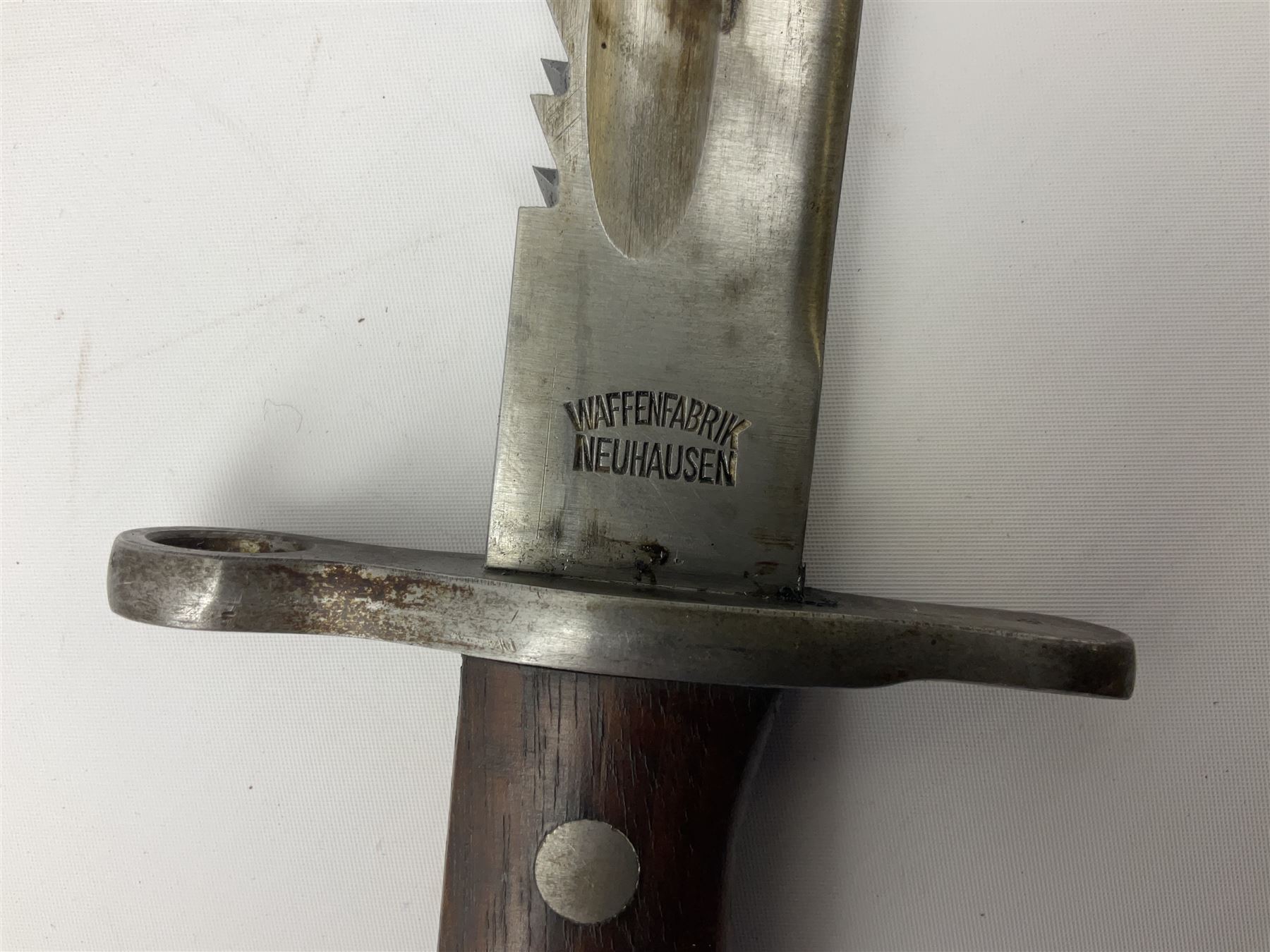 Swiss Schmidt-Rubin M1914 pioneer bayonet, with 48cm steel saw-back blade, the ricasso stamped, ''Waffenfabrik, Neuhausen'', the crosspiece stamped Swiss cross, steel scabbard, leather frog L64cm overall