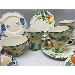 Art Deco tea service for six by Myott, Son & Co, painted with stylised orange and yellow flowers amongst green foliage on plain ground, together with a similar unmarked part tea service decorated with blue flowers