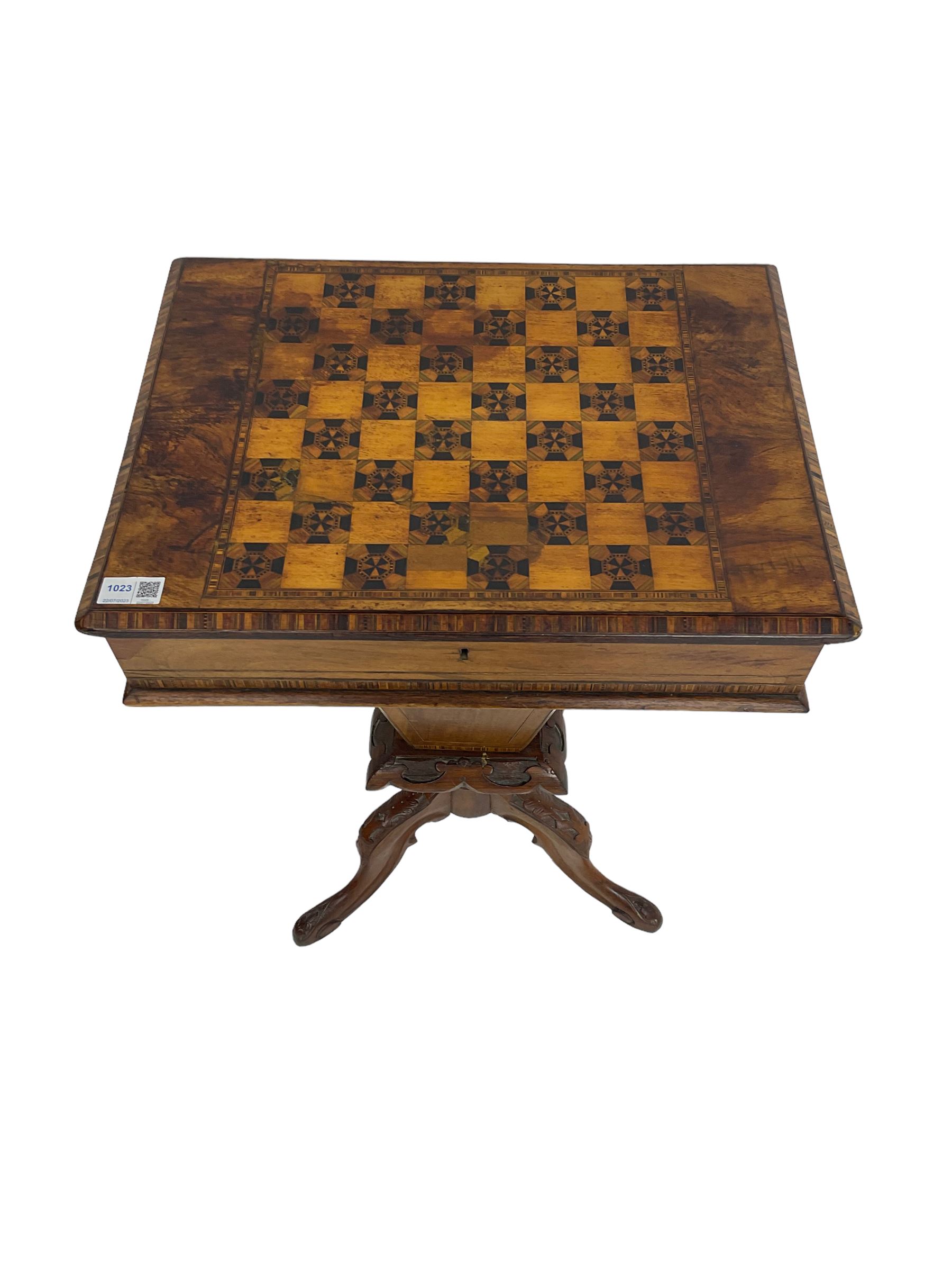 Victorian walnut work table, the rectangular hinged top inlaid with a chessboard design, canted edge with alternating ebony and satinwood inlays, concealing fitted interior, banded and strung frieze over tapering column well, collar carved with foliate decoration, on a cabriole tripod base