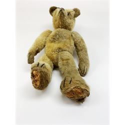 Early 20th century American mohair teddy bear c1920 with wood wool filled body humped back body with jointed limbs, black boot button eyes and horizontal stitched nose and mouth H12