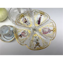 A 19th century glass comport, probably French, the lobed bowl decorated with printed figures and further heightened with gilt, H11.5cm D18.5cm, together with other 19th century glass, comprising clear epergne with single trumpet and etched foliate decoration throughout, H12.5cm, a pair of yellow satin glass vases with net effect decoration, H18.5cm, and a milch glass cup and saucer, with floral swag decoration and gilded rims, cup H6.5cm, saucer D11cm. 
