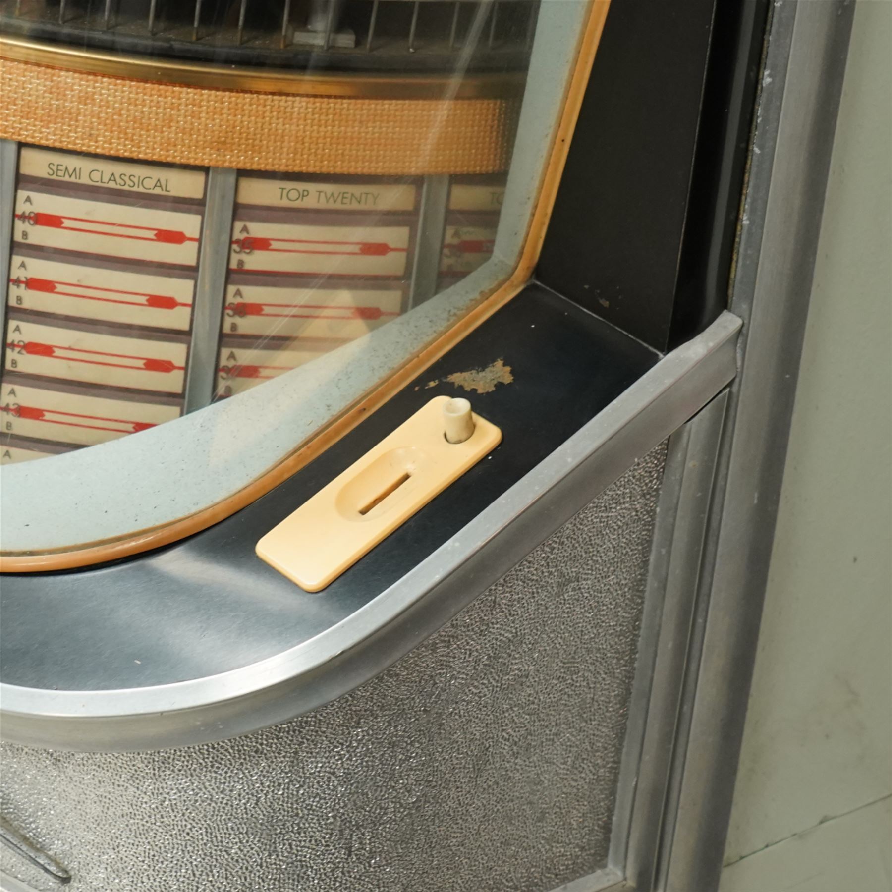 Ditchburn - 'Music Maker Panoramic 200' jukebox circa 1959, curved panoramic glazed front offering full view of the automatic selection process, accommodating 100 records (200 selections), with a stereo sound system, the aluminium trim over a woven speaker grille with an all-over ebonised and silver finish