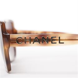 Chanel - pair of oversized sunglasses, with translucent tortoiseshell-effect brown acetate frames and gradient tinted lenses, the arms boldly set with gold-tone ‘CHANEL’ lettering, with original quilted leather case, booklet and box