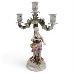 Pair of 19th Century German three-branch figural candlesticks, the figures each in floral dress against a tree, the branches decorated in relief with roses and the sconces painted with insects, H33cm 
