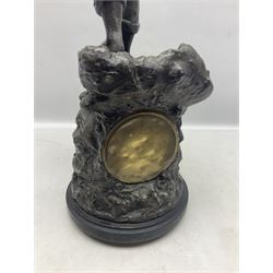 Early 20th century spelter effect figure of a sailor standing in the bow of a boat scanning the horizon, on a simulated rock base with a plaque entitled 'Rescue', base fitted with a timepiece clock movement and two-part dial, with pierced hands, gilt dial centre and ivorene chapter ring written in Arabic numerals, German HAC spring driven going barrel movement wound from the front; with pendulum H65.5cm

