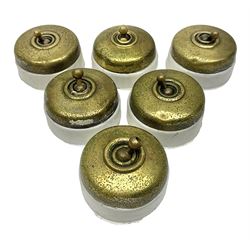 Six early 20th century brass toggle light switches, with painted ceramic base, D5.5cm
