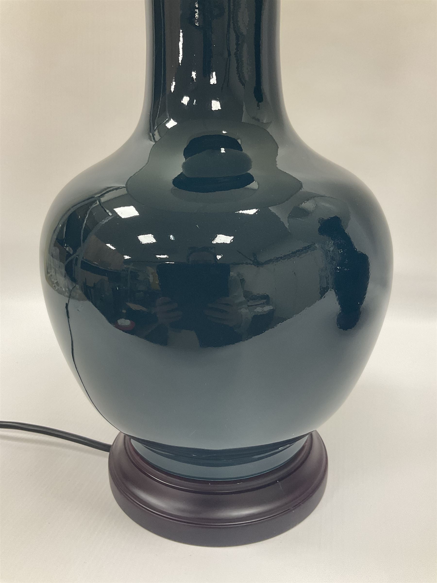Pair of Chinese teal glazed table lamps, each of bottle form, raised upon circular hardwood bases, including shade H72cm 