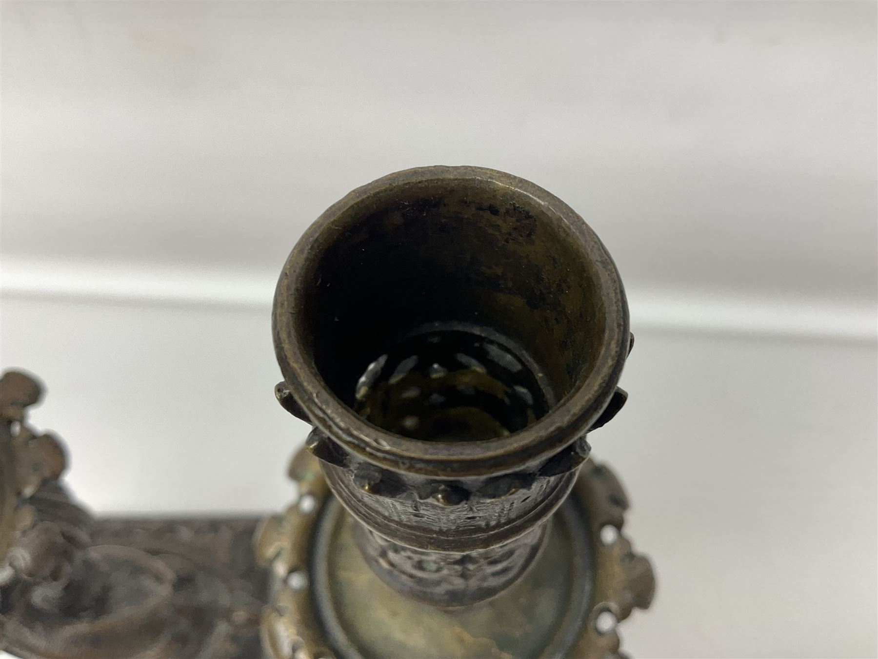 Pair of late 19th/ early 20th century brass candlesticks in the form of dolphins upon a stepped base with Fleur-de-lis design, H32cm 