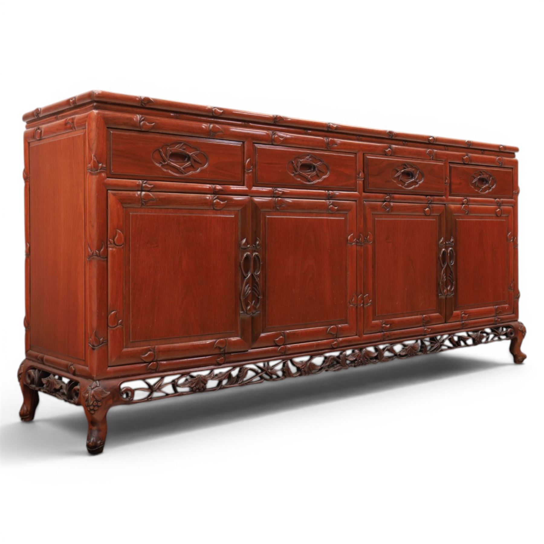20th century Chinese ornately hardwood sideboard, rectangular top over four drawers above four cupboards, pierced carved apron, raised on cabriole legs 