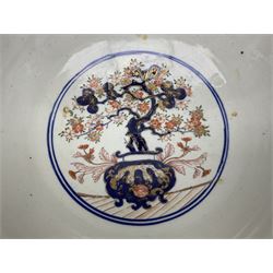 Late 19th century Japanese Imari jardinière of fishbowl form, decorated with shaped panels of stylised flowers, blossom and foliate motifs with gilding throughout above a blue and white geometric pattern band, the interior decorated with roundel of a bonsai tree in pot, with character mark beneath, H21.5cm D37cm